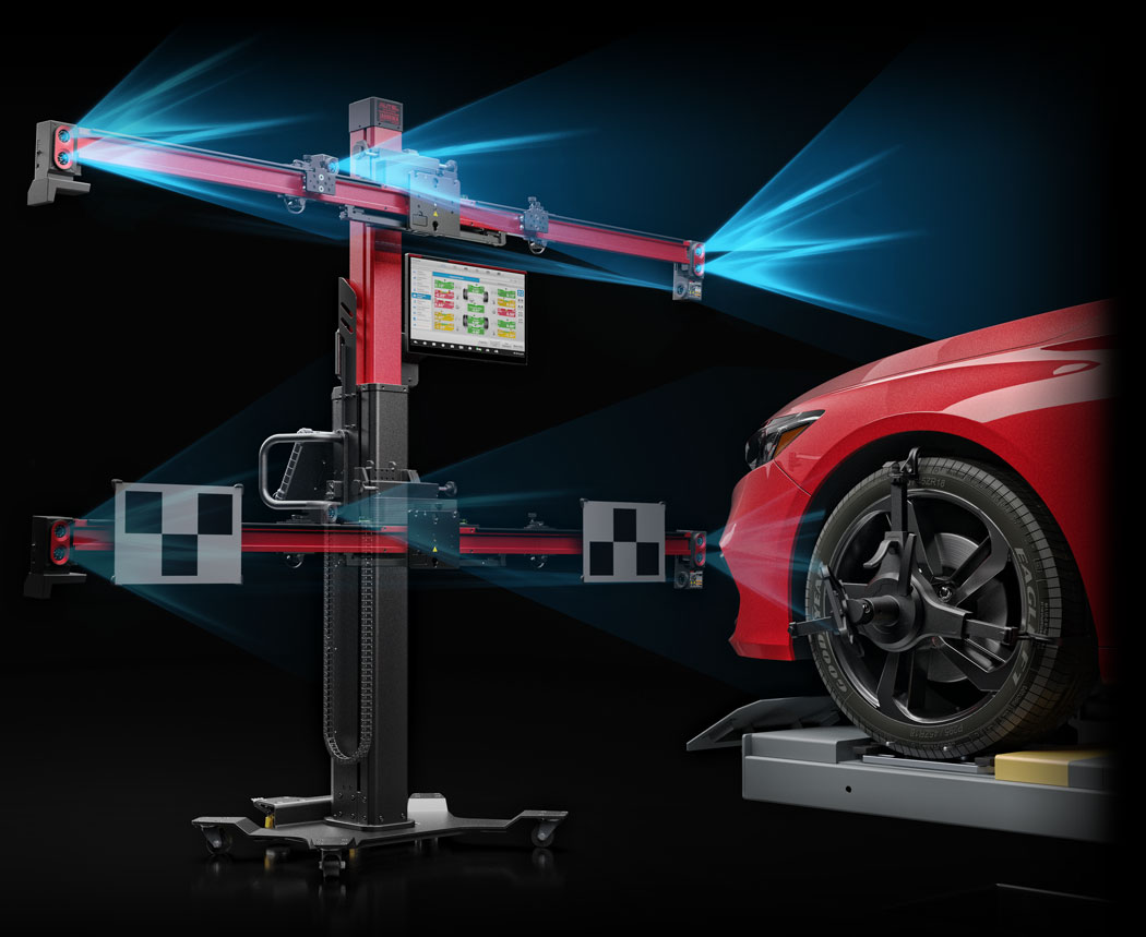 Autel IA900WA wheel alignment and ADAS calibration system operating beside a vehicle